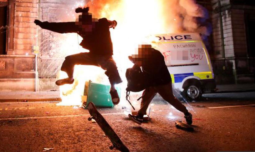 Skateboarder doing sweet tricks in front of burning cop van in Bristol on March 21, 2021, photographer catching the moment