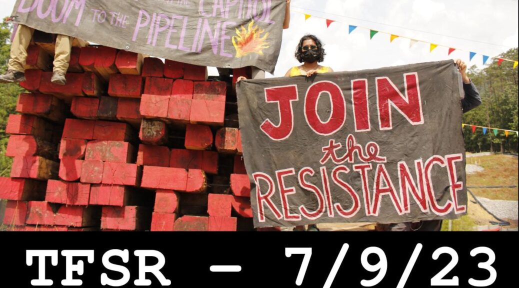 Protestors on Mountain Valley Pipeline work site disrupting, near a pile of timber with signs against the pipeline + text "TFSR - 7/9/23, Continuing Struggle Against The Mountain Valley Pipeline"